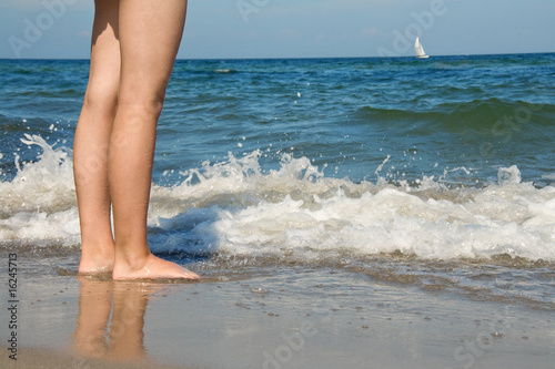 Legs of young girl at the sea