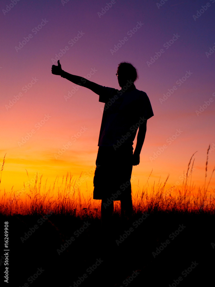 Young man silhouette in sunset Young man silhouette in sunset