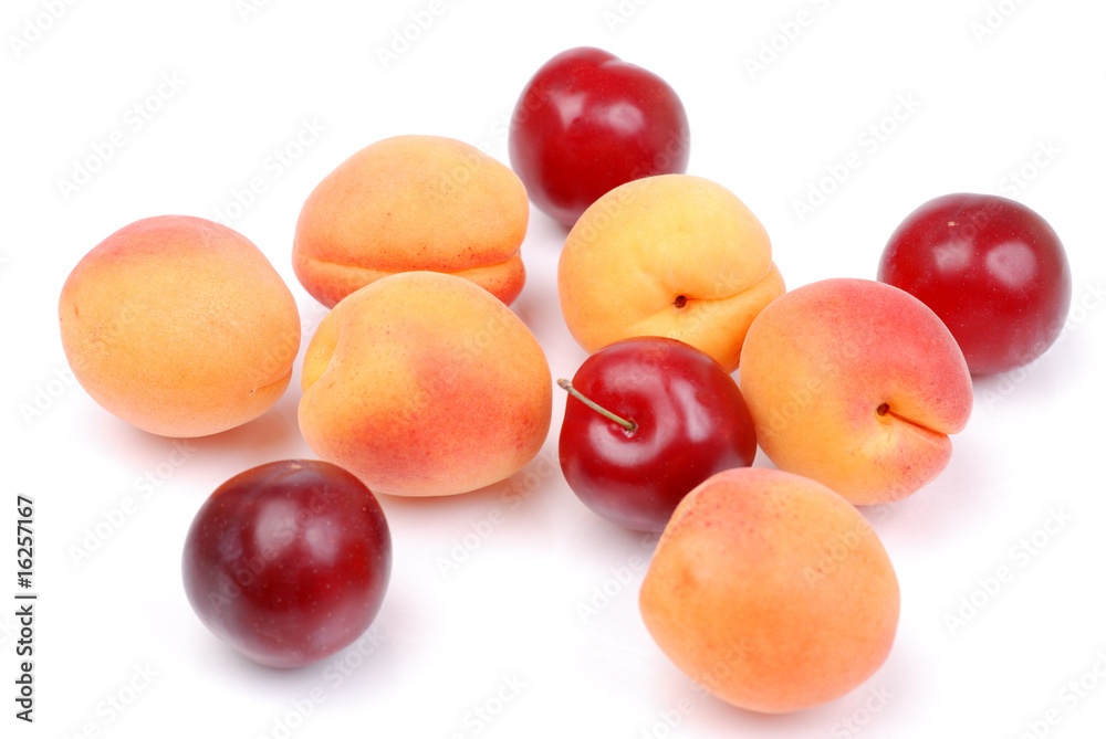Ripe apricots and plums on white