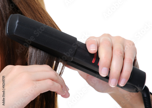 flat iron applying on female brunette hair