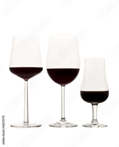 Three glasses of red wine isolated on white background