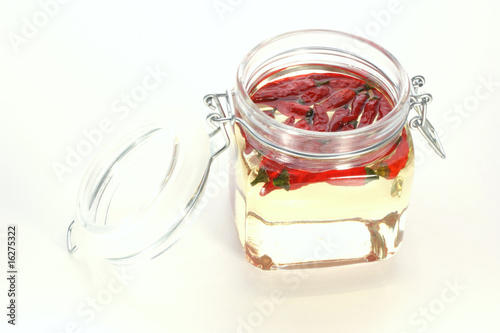 organic red chili in a jar with oil