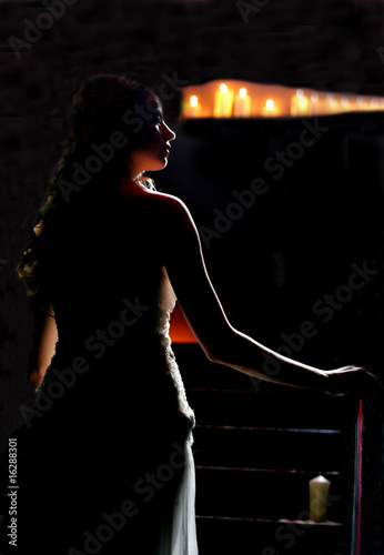 Woman walking in candlelit church