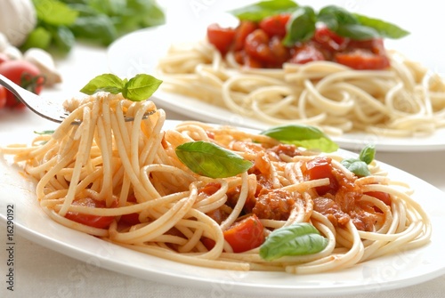 Fork with pasta and basil leaf