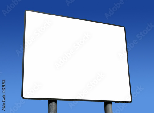 Big blank white sign ready for text and blue sky.