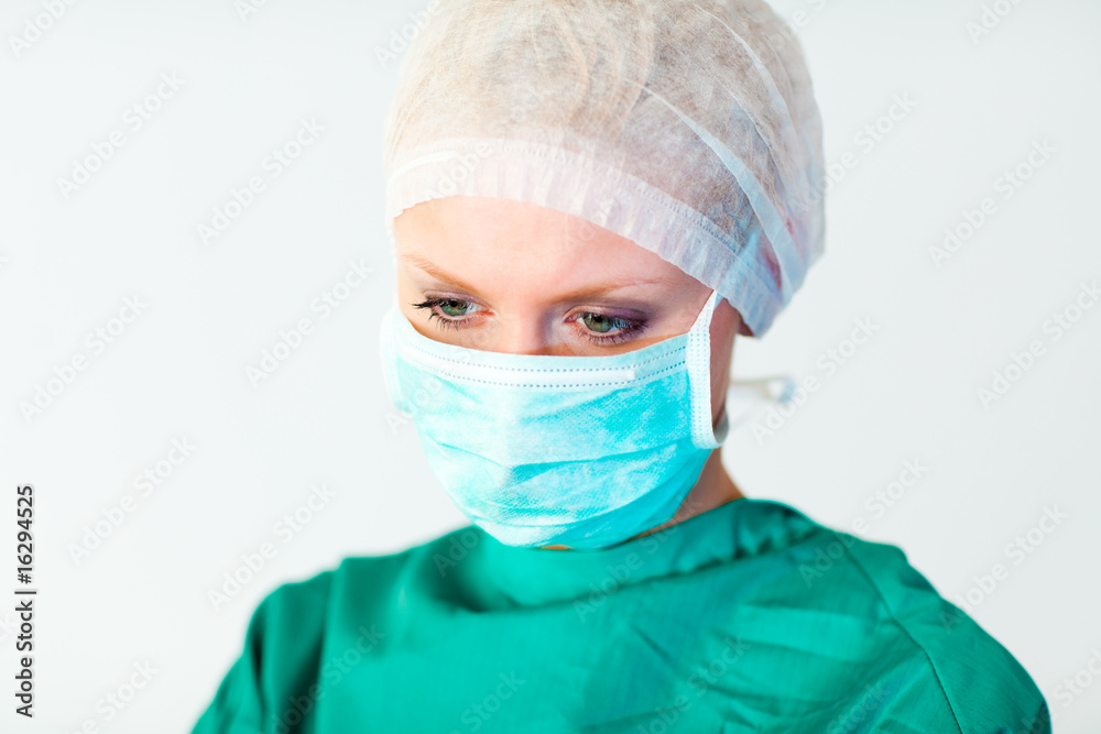 Young female doctor with mask and looking down Young female doctor with mask and looking down