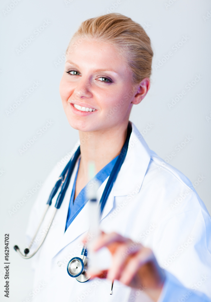 Young female doctor holding an injection Young female doctor holding an injection