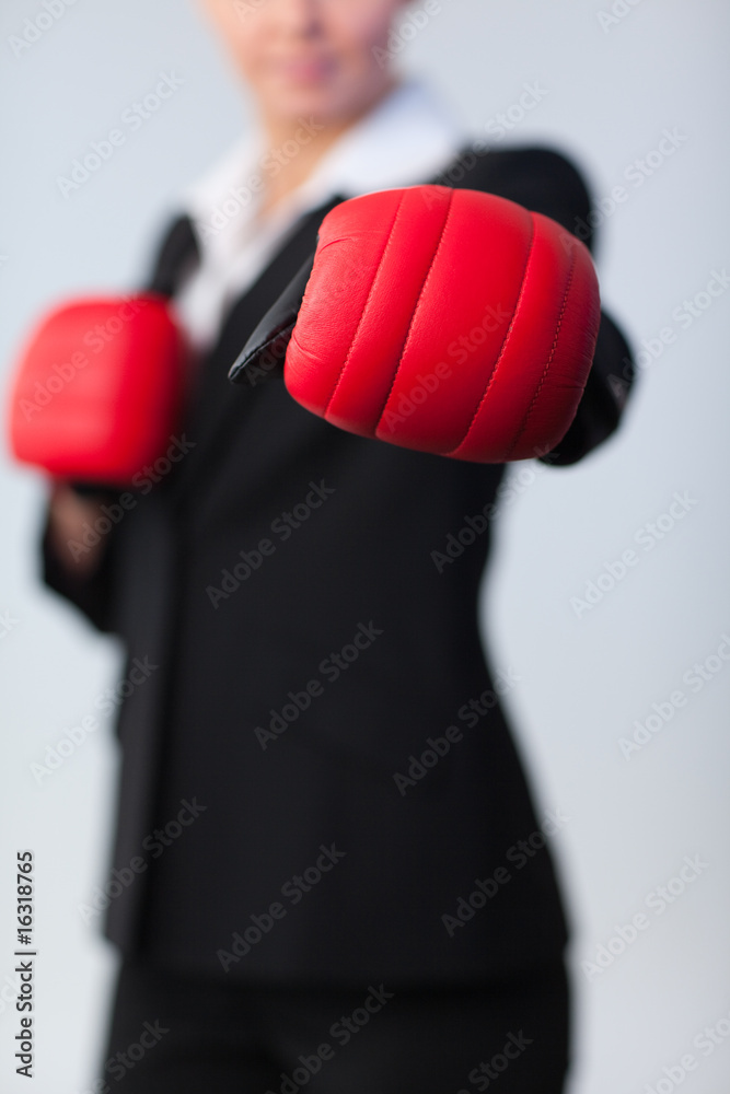 woman showing boxing glove to the camera woman showing boxing glove to the camera