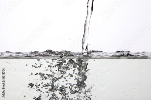 pouring water to the container with white background