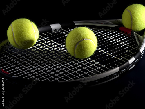 tennis racket with three balls