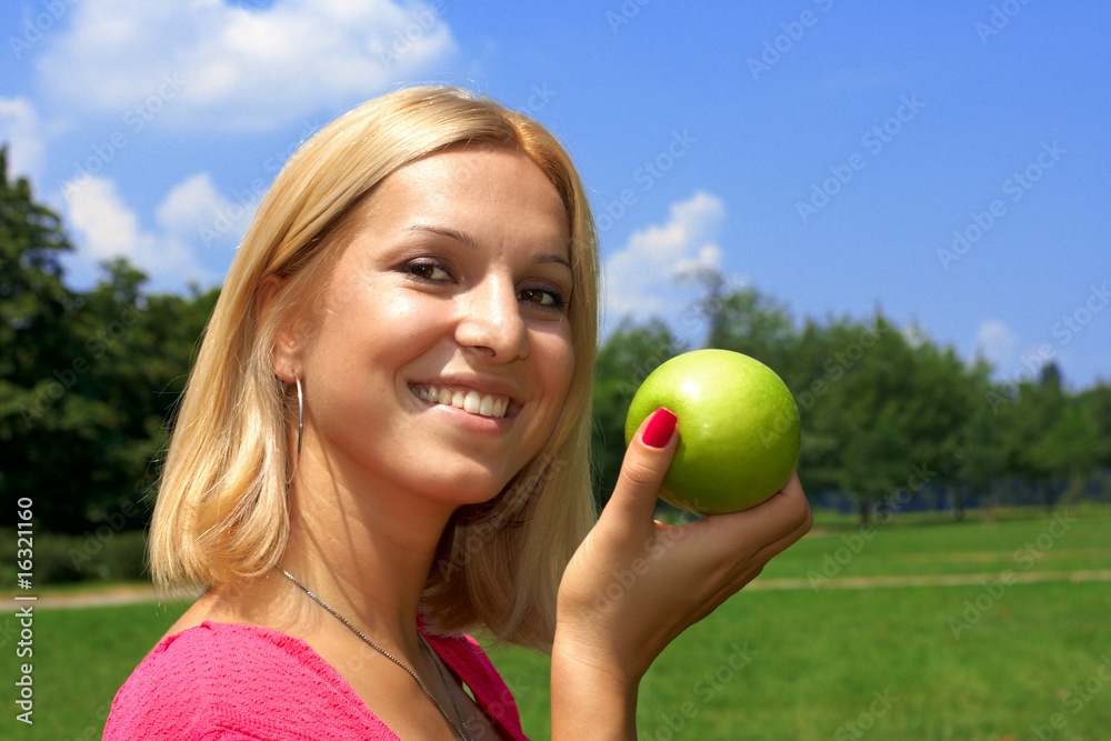 Beautiful woman holding green apple outdoors. Beautiful woman holding green apple outdoors.