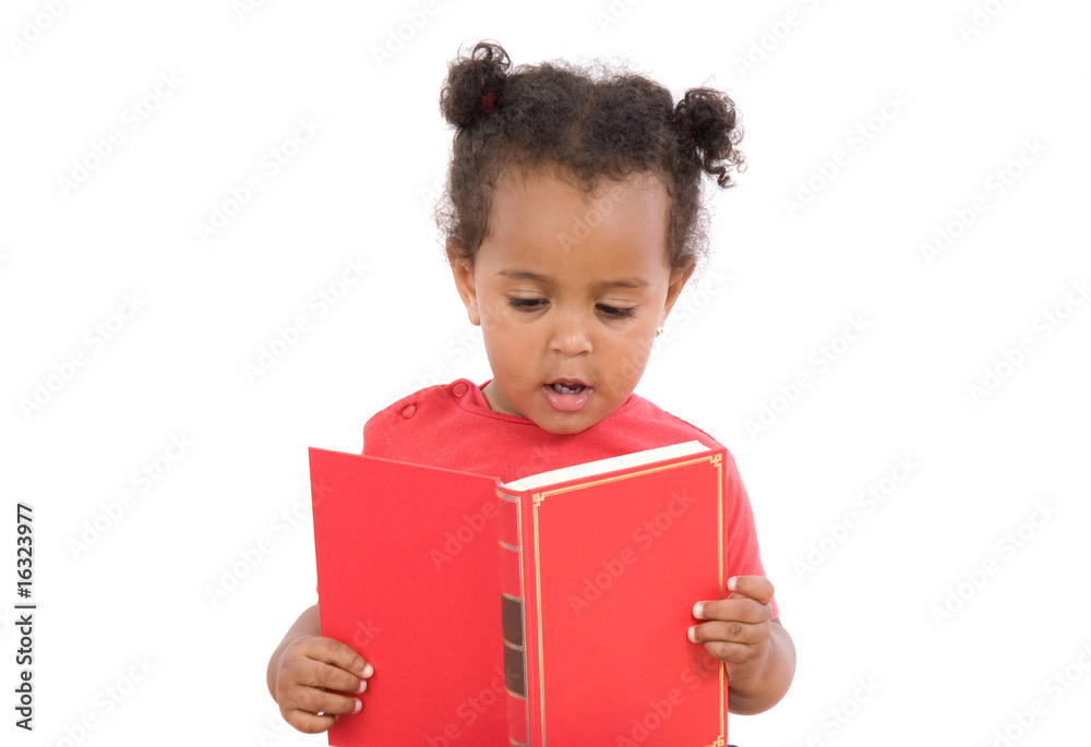 Baby reading sitting on a pile of books