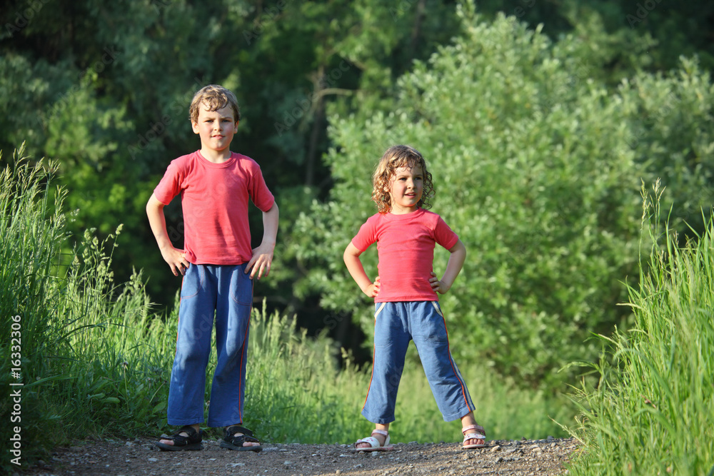 Fototapeta premium boy and girl make gymnastic in park