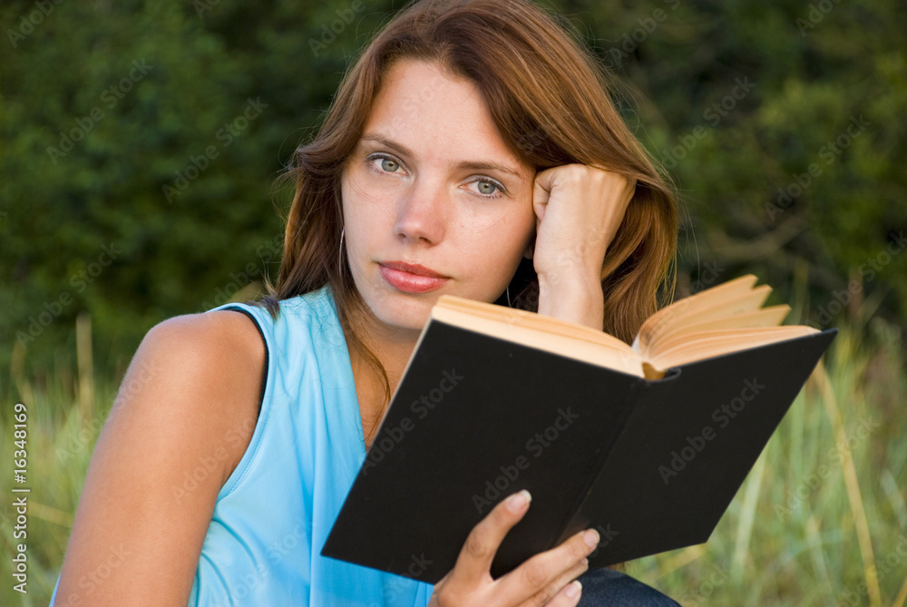 young woman reading book young woman reading book