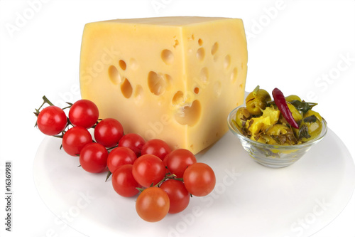 big chunk of yellow cheese with olives