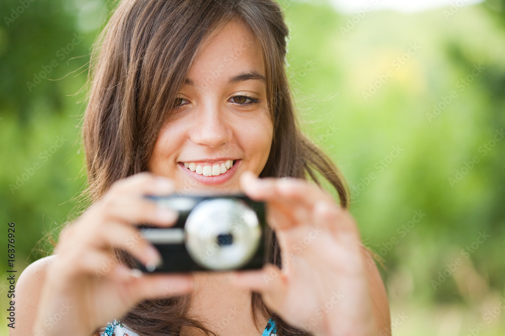 Young lady taking photos outdoors Young lady taking photos outdoors