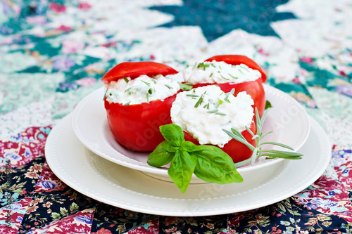 Herbed Stuffed Tomatoes with caps on top. photo