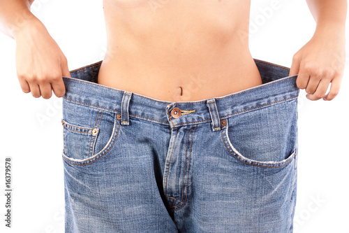 Fotografie Young lady with huge jeans, weight loss concept