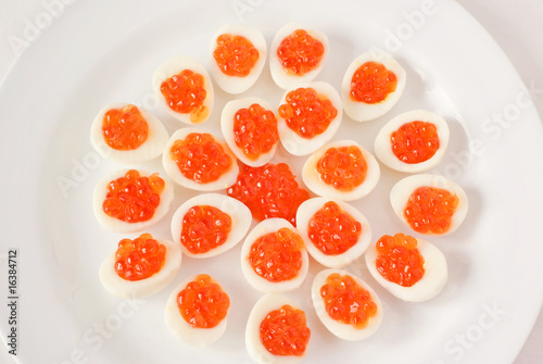 Snack of the quail eggs and caviar