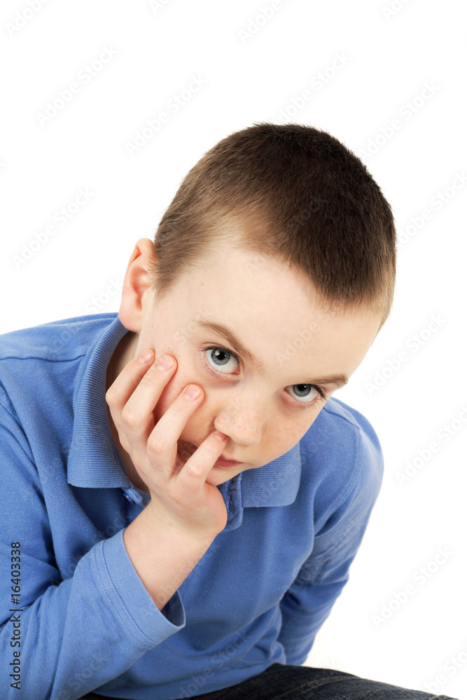 Portrait of young boy looking at camera, studio shot Portrait of young boy looking at camera, studio shot