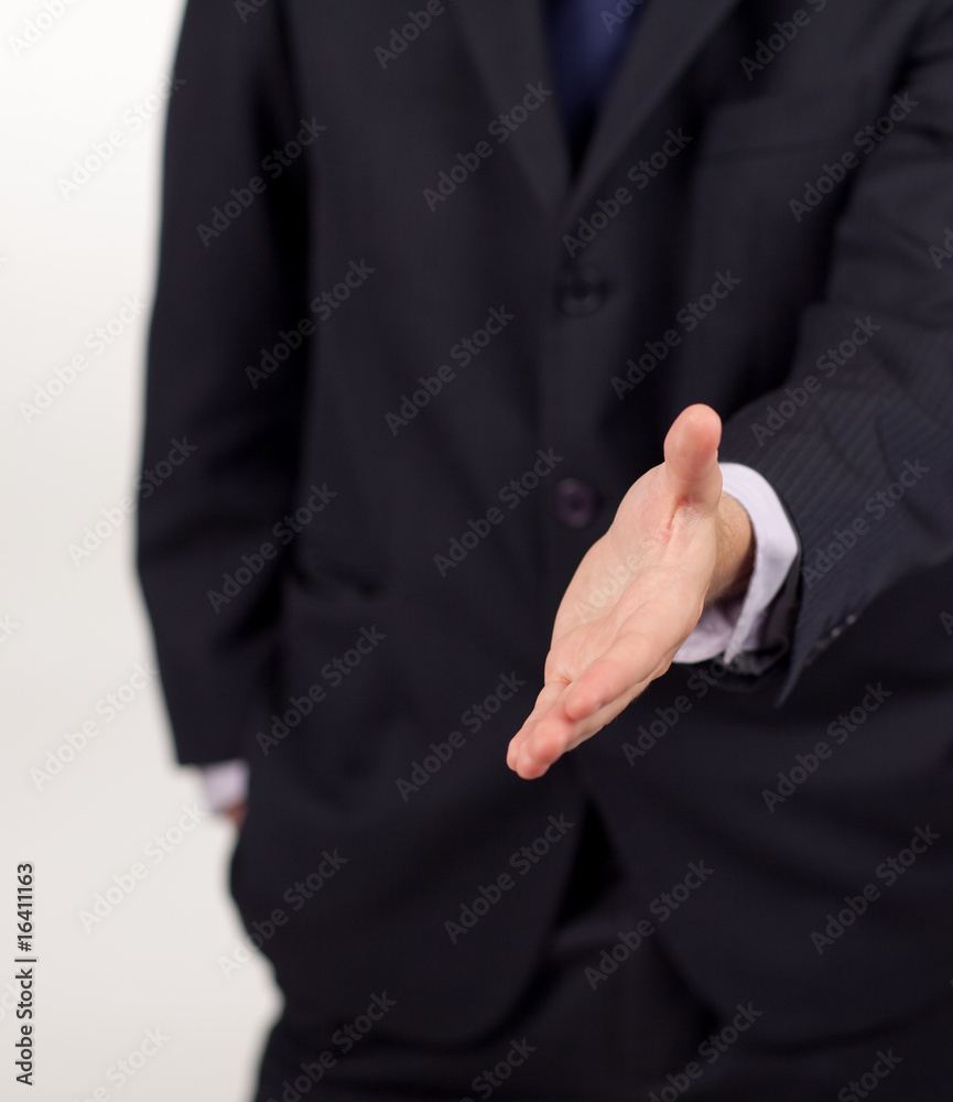 businessman showing a handshake to the camera businessman showing a handshake to the camera