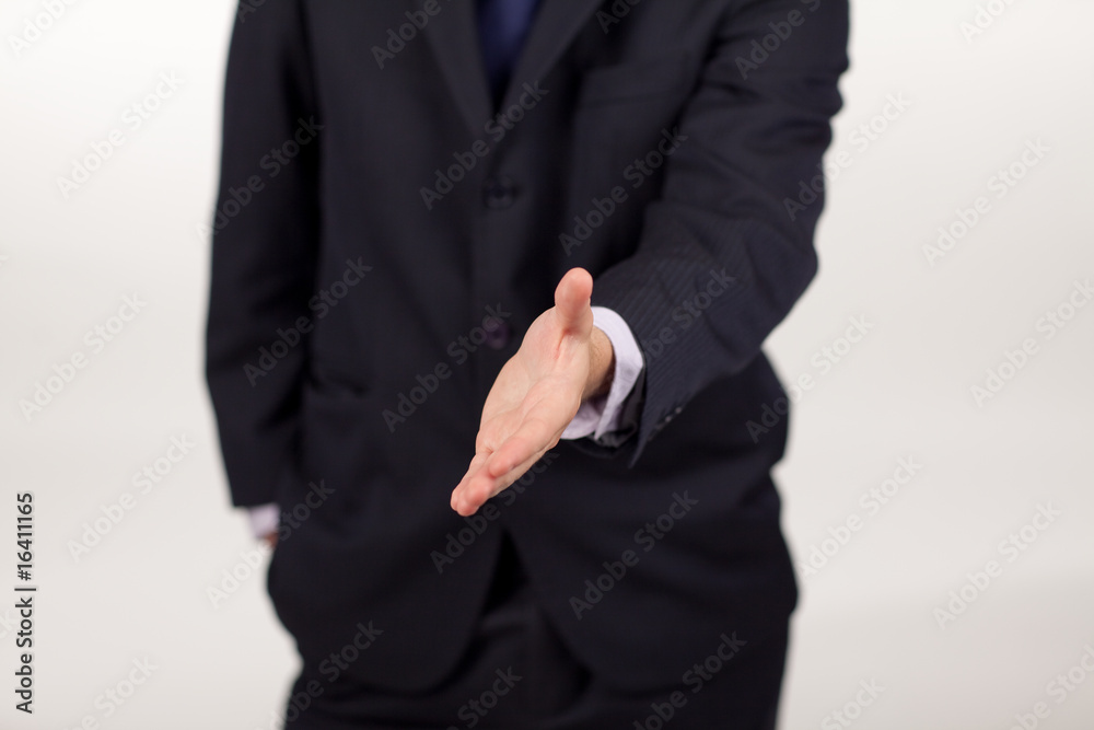 businessman showing a handshake to the camera businessman showing a handshake to the camera