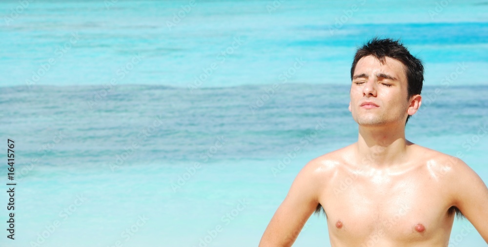 Man standing up sunbathing in a Maldivian Island Man standing up sunbathing in a Maldivian Island