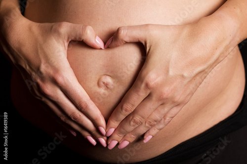 Wallpaper Mural Heart shaped hands on pregnant belly Torontodigital.ca