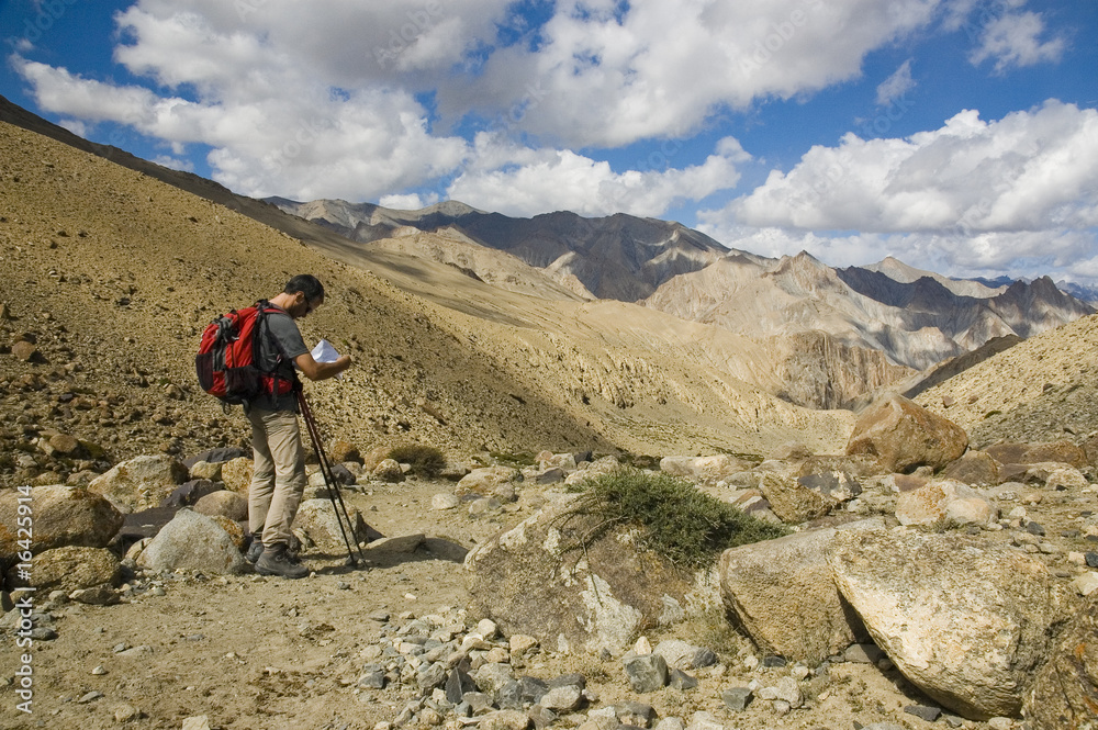 Hiker looking his map in Markha Valley. Indian Himalaya