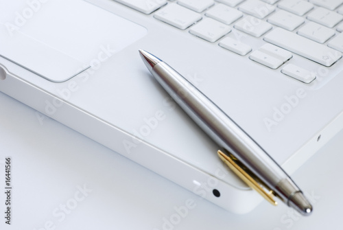 Silver pen on a laptop keyboard