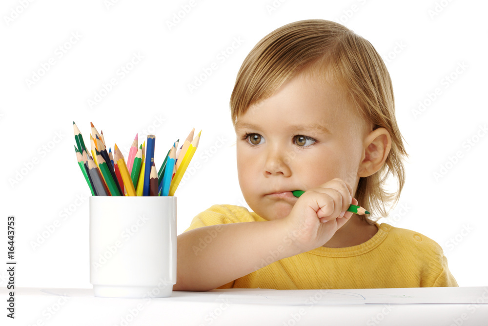 Child bites green crayon and thinks about ideas Child bites green crayon and thinks about ideas