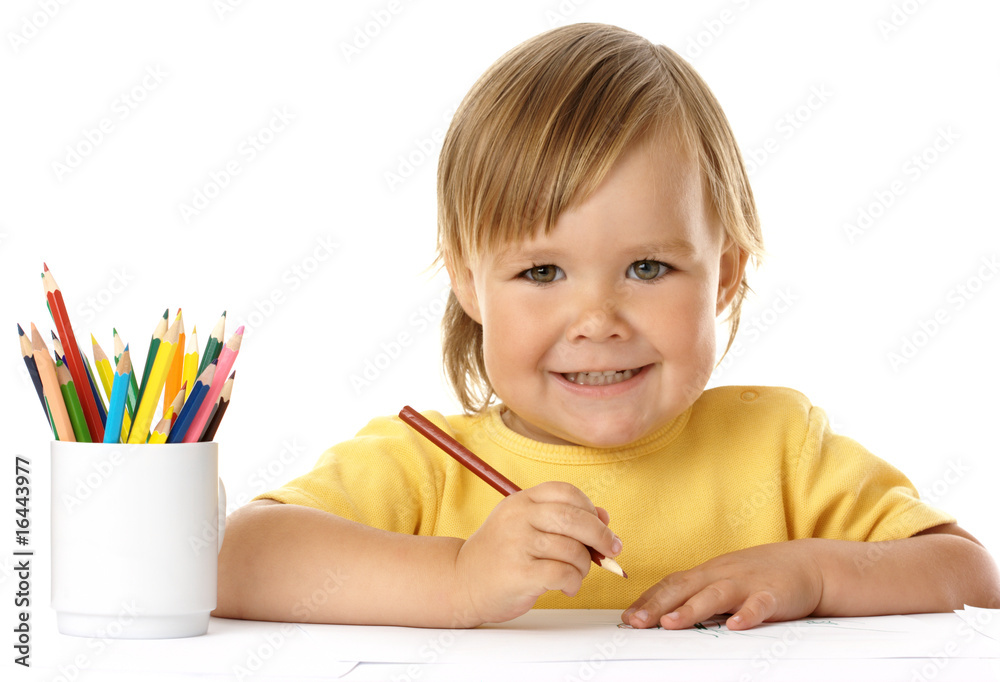Cute child draw with crayons and smile Cute child draw with crayons and smile