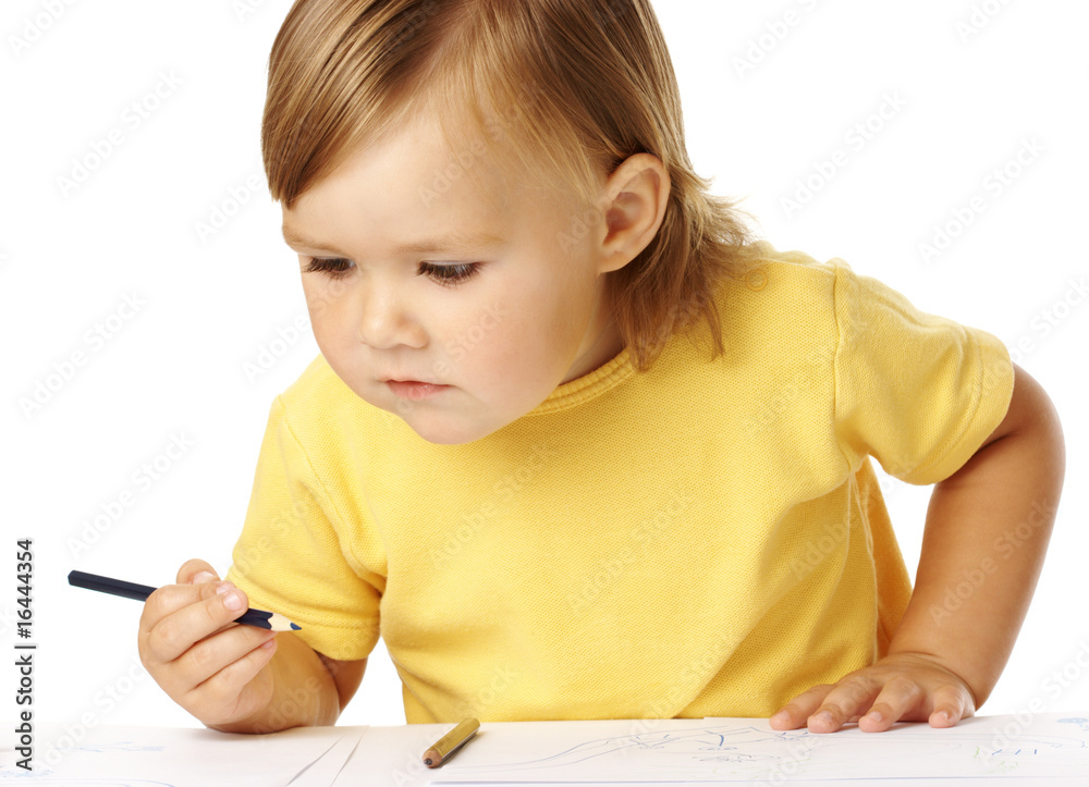 Child half-rise from table, playing with crayons Child half-rise from table, playing with crayons
