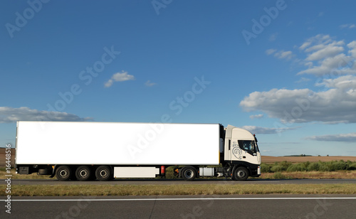 Long white truck on highway