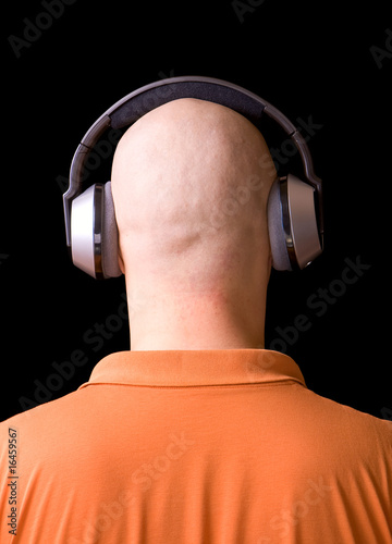 bald man listening to music