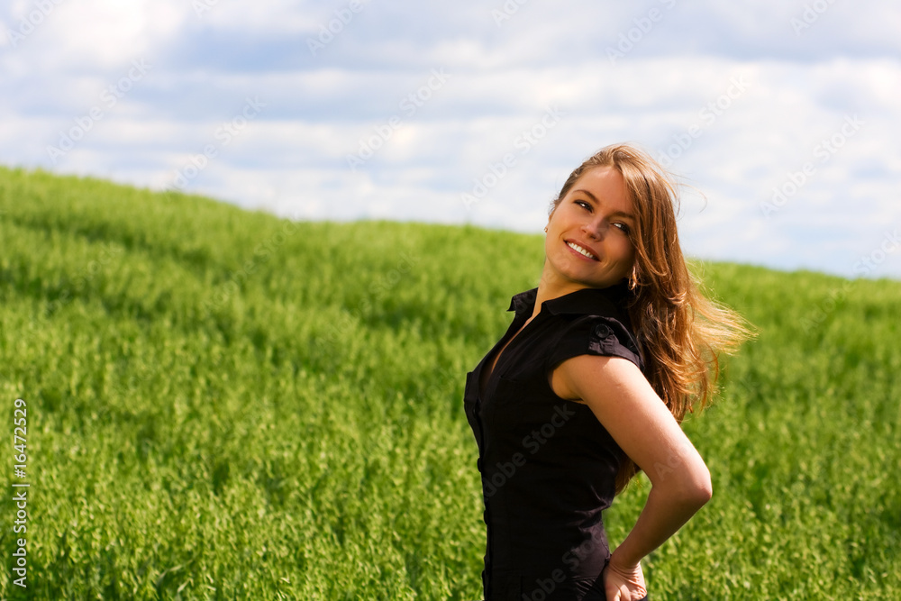 Happy young woman in a field. Happy young woman in a field.