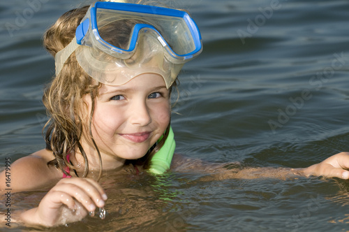Little girl in the water with snorkel