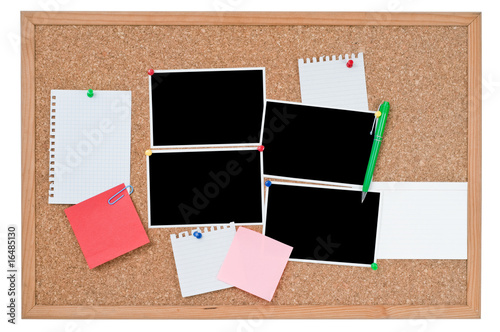 Cork board with blank photo prints and notes