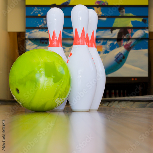 green bowling ball and pins