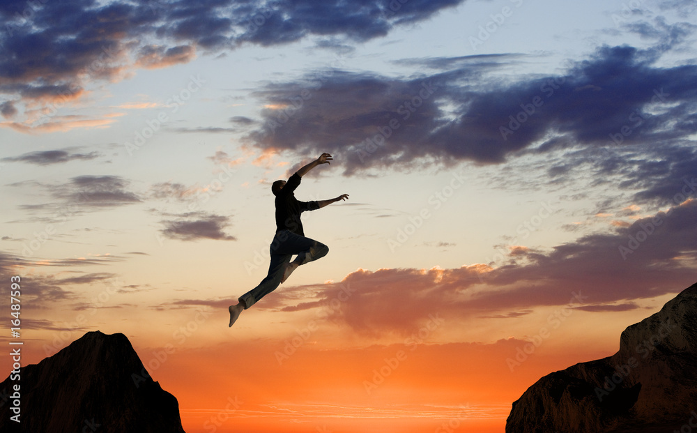 Man Leaping Mid-air on Mountainside Man Leaping Mid-air on Mountainside
