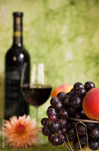 Red vine with red grapes and flower