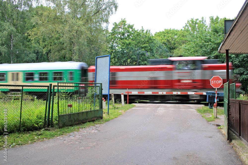 Train passing the road crossing at high speed Train passing the road crossing at high speed