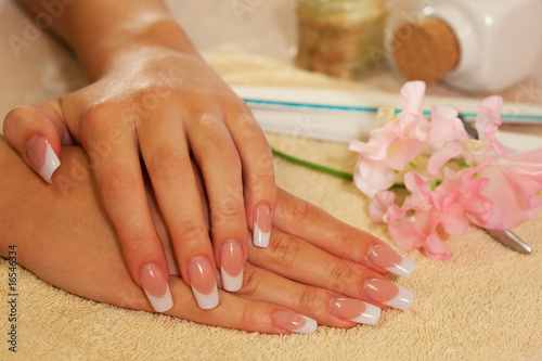 Hands of young woman with french manicure photo