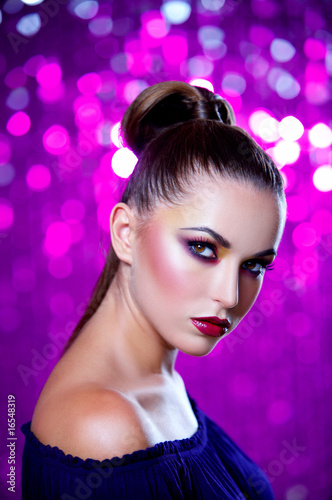Portrait of beautiful young sexy woman on crimson background