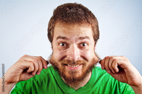 Funny guy pulling hairy patchy beard