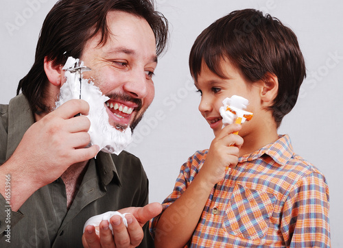 Father is teaching his boy how to shave