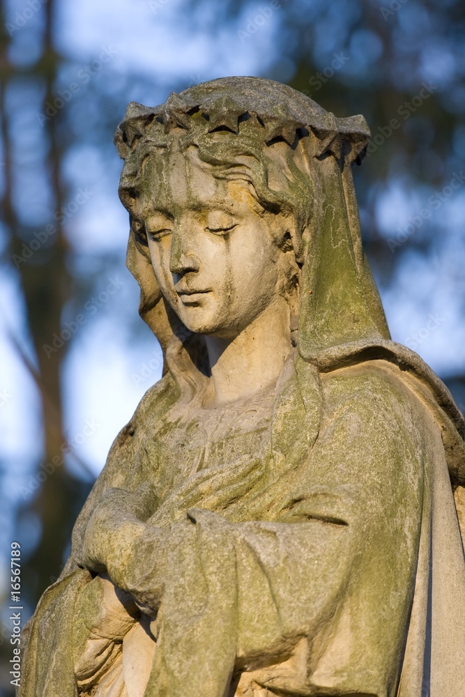 Sculpture of Holy Mary on a graveyard.