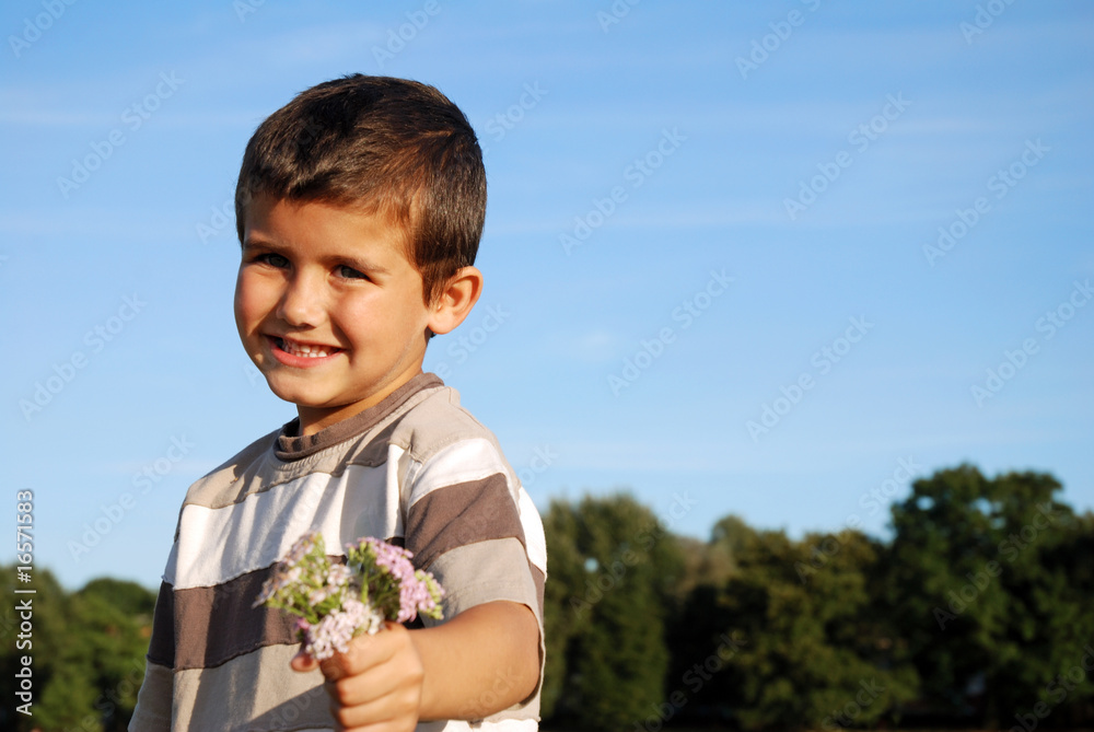 Young boy holding bunch of flowers Young boy holding bunch of flowers