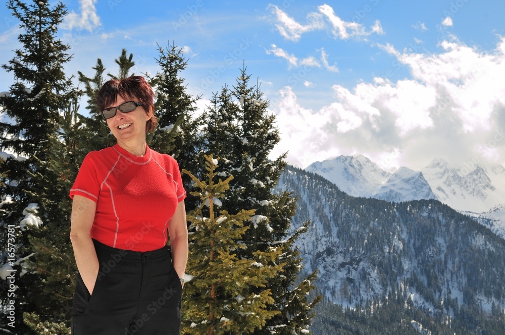 Winter portrait of senior woman in mountain snowy land