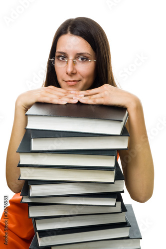 Clever woman student on pile of books